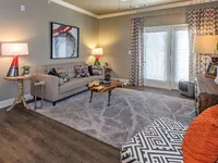 Living room with double, windowed doors to the patio.