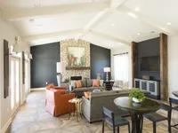 Clubhouse interior with seating and a fireplace.