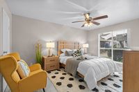 Bright and cozy bedroom featuring modern decor, a comfortable queen bed, and a calming yellow armchair.