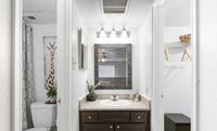 Contemporary bathroom with a stylish mirror, elegant vanity, and artistic giraffe wall art for a chic aesthetic.