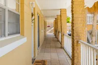 Outdoor hallway leading to apartment home entrances.