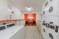 Community laundry facility with washers, dryers, and tiled floors
