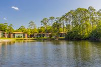 Community lake with apartment buildings in the background.