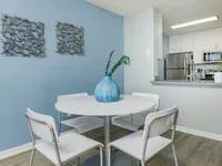Dining area with small circular table and four chairs.