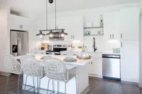 Kitchen with breakfast island, stainless appliances.
