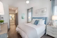 Bedroom with bed, dresser, nightstand.
