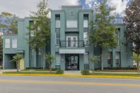 Facade of College Park and College Park at Midtown leasing office.  Trees in front of building.