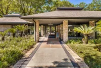 Leasing office entrance with palm trees surrounding it,