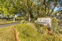 Community entrance with monument sign reading
