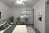 Bedroom with low queen bed and desk