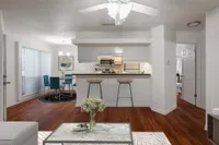 Living room overlooking kitchen with breakfast bar and dining room