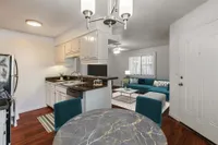 Living room overlooking kitchen with breakfast bar and dining room
