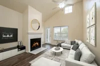 Living room with tv, fireplace and vaulted ceilings