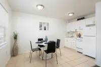 Kitchen/dining area with black chairs and dining table