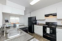 kitchen with black appliances and vinyl countertops