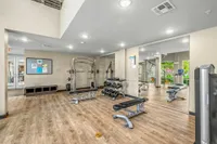 Community fitness center with various cardio and weight machines.