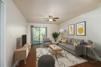 Living room with gray couch, tv, and sliding glass door