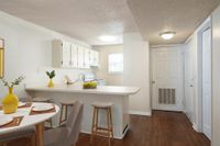 Kitchen with barstool, dining table and lemons