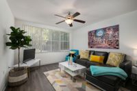 Dining and living room area.  Table and chairs, sofa and chair in background.