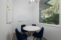 Study room with four chairs and a white board