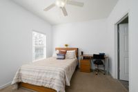 Carpeted bedroom with bed with gray bedspread