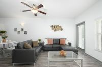 Living room area with large window and door out to balcony