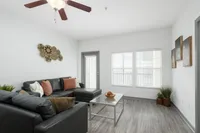 Living room area with large window and door out to balcony