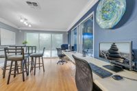 Community computer lab with hardwood floors, computers, and a blue wall.