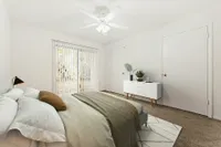 Bedroom with night stand and glass back door and closet