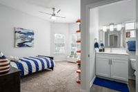 Childs bedroom with bathroom. Twin bed with blue comforter