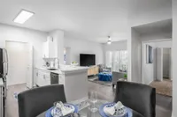 Kitchen and dining area looking into Living room with couch and ottoman