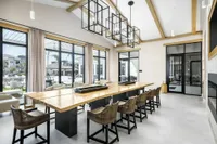 Clubhouse table with tv, coffee bar and fireplace
