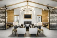 Clubhouse sitting area with couches, tv, fireplace, and chairs