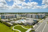 Aerial photo of Sorrento featuring buildings, clubhouse, and pool