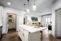 Kitchen with granite countertops and living room