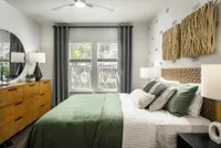 Bedroom with green bed and dresser