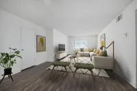 Bright, stylish living room with a spacious L-shaped sofa, modern decor, and a large window.