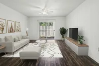 Elegant living room with chic decor, comfortable sofa, and stylish entertainment center overlooking a cozy patio.