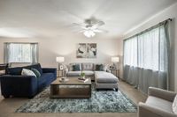 Elegant living room with modern furnishings, featuring a large comfy sectional, plush accent pillows, and soft natural lighting.