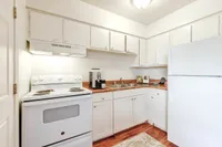 Bright and inviting kitchen with modern white cabinets, sleek countertop, and convenient appliances.