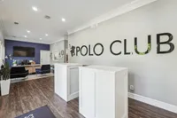 Elegant and welcoming lobby area of Polo Club featuring stylish furnishings, modern decor, and a sleek reception desk.