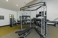 Modern fitness center with state-of-the-art equipment, including weights and resistance machines, ideal for an active lifestyle.