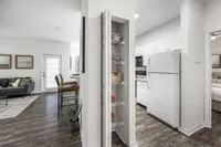 Bright and inviting apartment showcasing modern kitchen, cozy living room with stylish decor, and sleek hardwood floors.