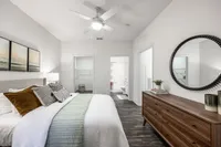 Chic bedroom with elegant decor, spacious walk-in closet, and modern ensuite bathroom, offering a serene living experience.