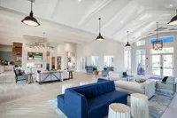 Elegant and spacious lounge area featuring modern seating, high ceilings, and abundant natural light.