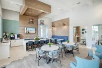 Modern apartment lounge with chic decor, featuring elegant seating, stylish wooden accents, and vibrant blue tiles. Ideal for relaxing or social gatherings.