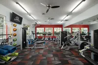 Bright, modern fitness center featuring top-of-the-line equipment, vibrant flooring, and large windows for natural light.