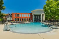 Luxurious swimming pool area with modern architecture and expansive seating, perfect for relaxation and leisure.