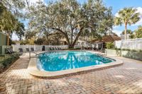 Inviting pool area featuring crystal-clear water, sun loungers, and lush greenery, perfect for relaxation and leisure.