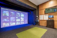 Luxurious game room with a state-of-the-art sport simulator, vibrant game library, and sleek decor.